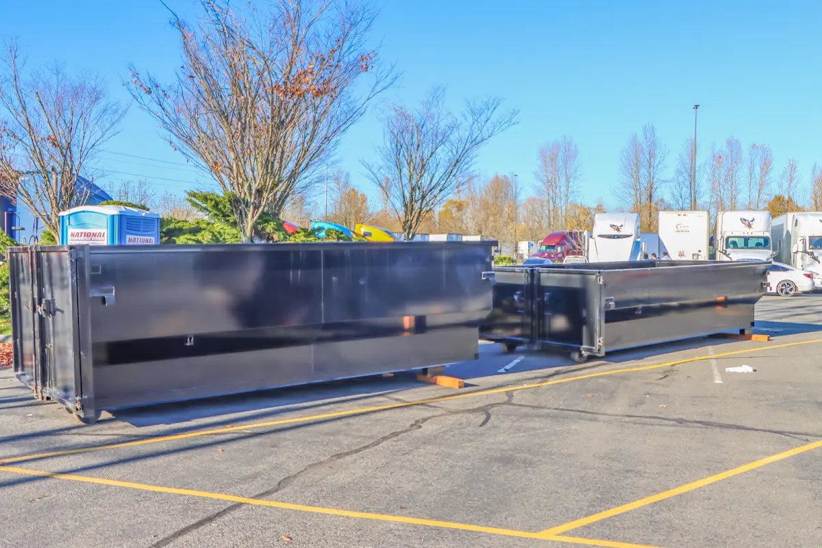 Professional dumpster rental service with roll-off container on residential driveway in Grove City